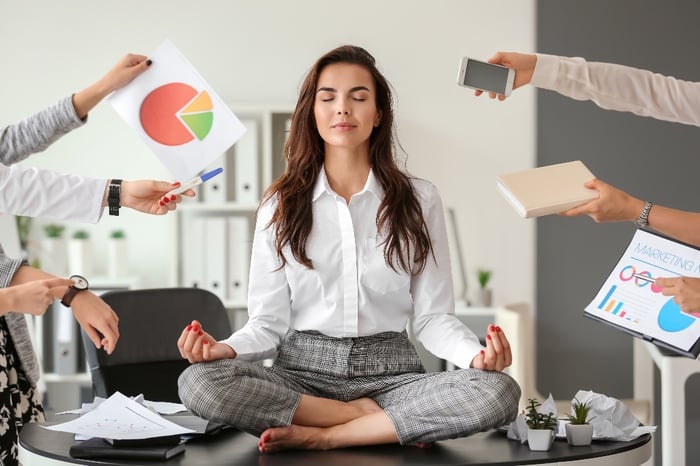 person doing yoga on desk