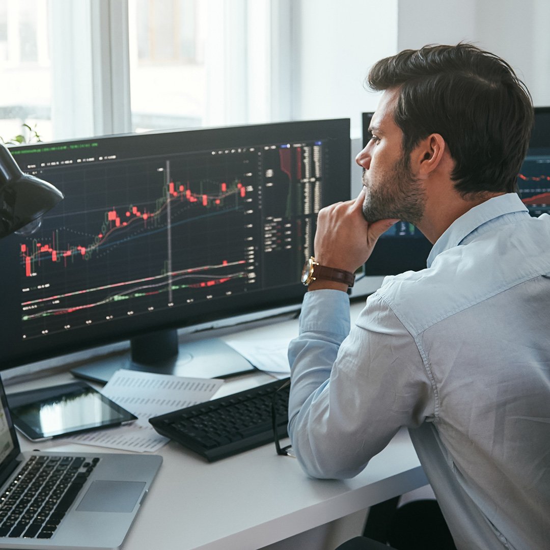 business-professional-studying-data-multiple-screens