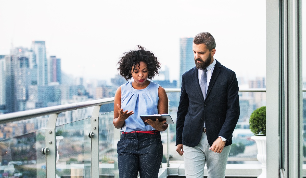 Colleagues walking holding tablet